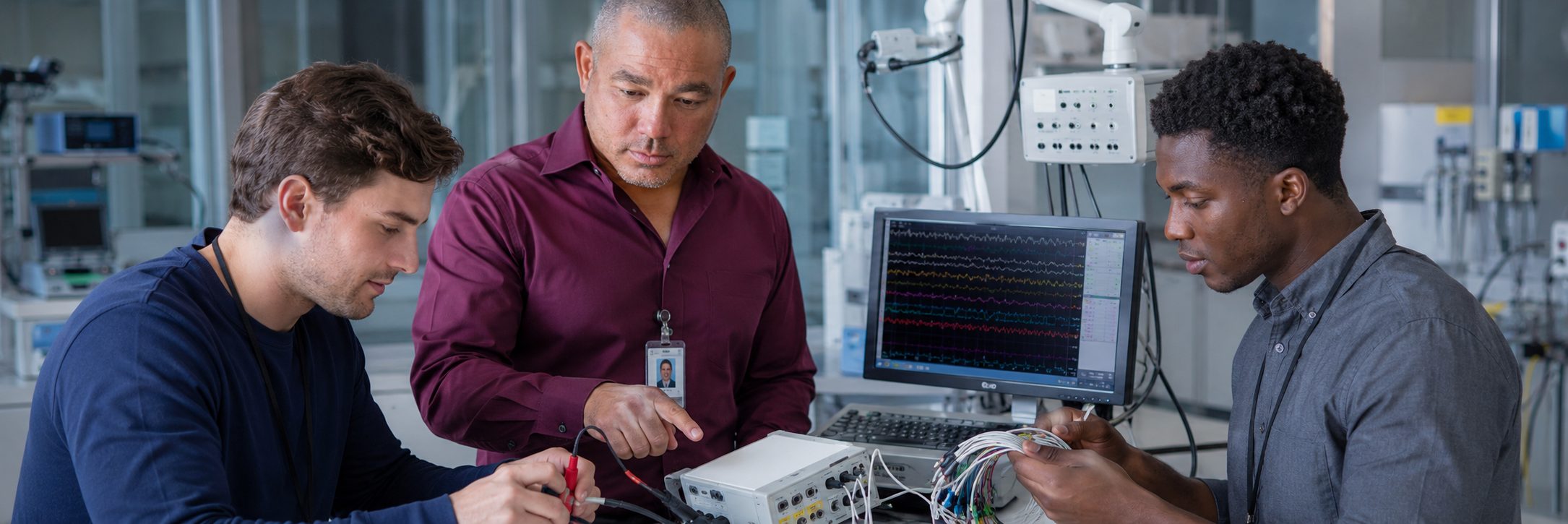 HTM technicians inspecting operating room surgical lights during scheduled service